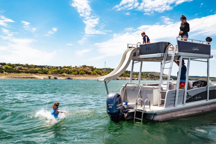 a person riding on the back of a boat in the water