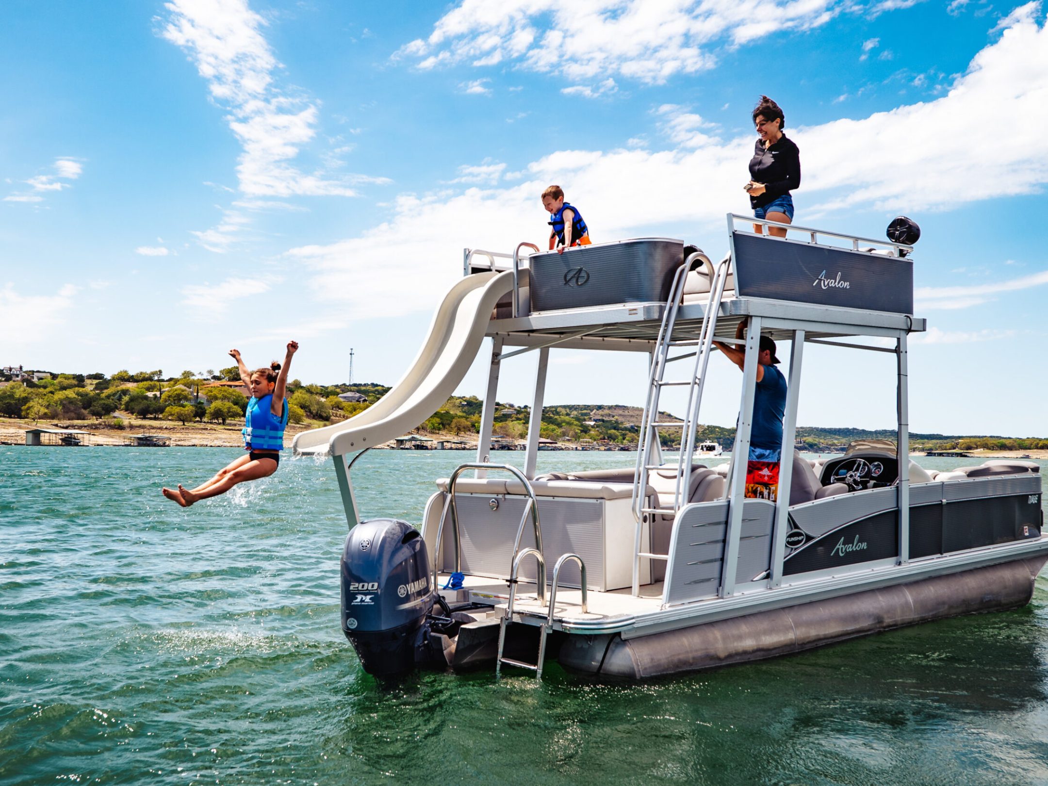 a man riding on the back of a boat in a body of water