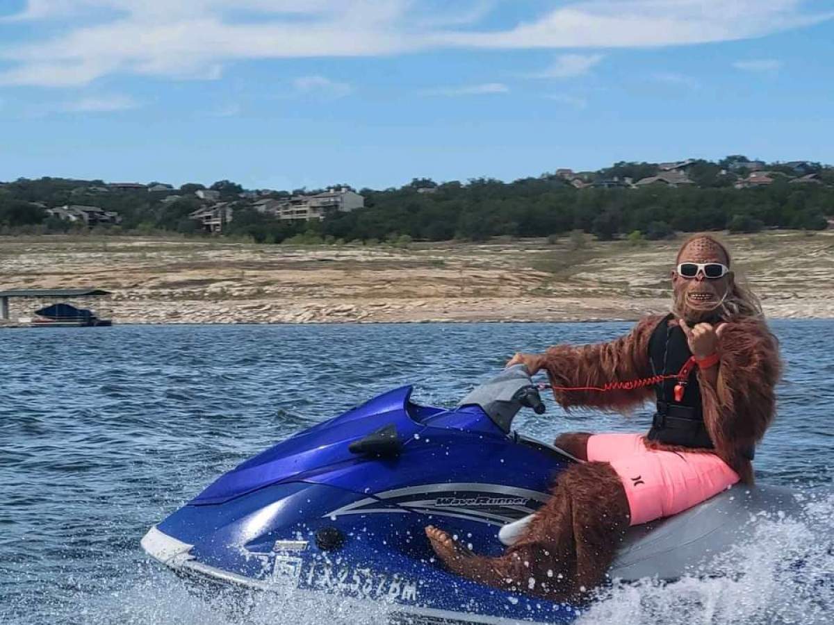 a person riding on the back of a boat in a body of water