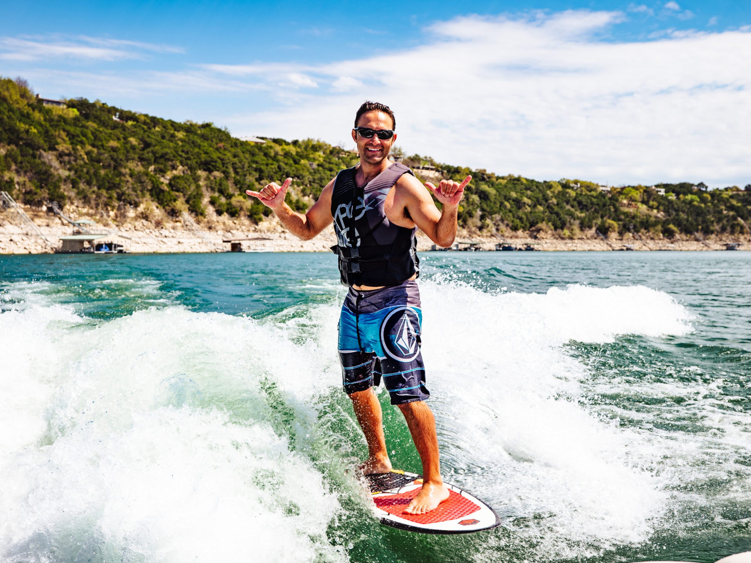 a man riding a wave on a surf board on a body of water